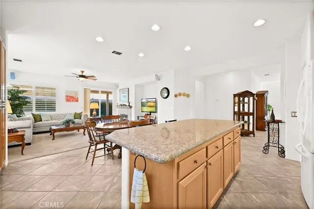 a view of a dining room and livingroom with furniture wooden floor and a rug