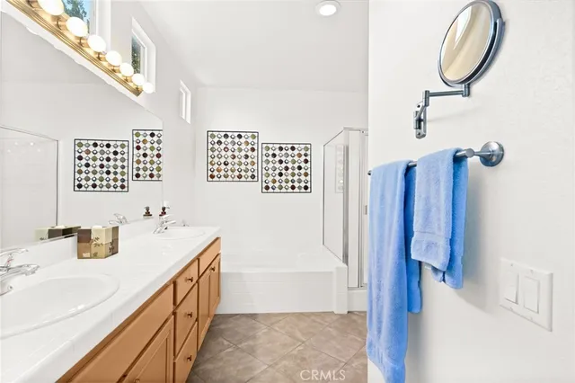 a bathroom with a sink double vanity and a bathtub