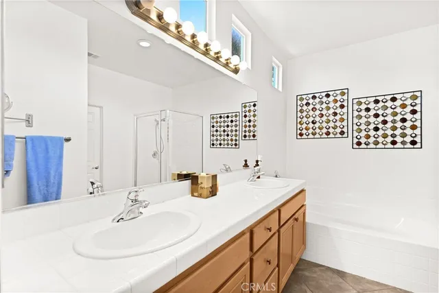 a bathroom with a shower sink and mirror