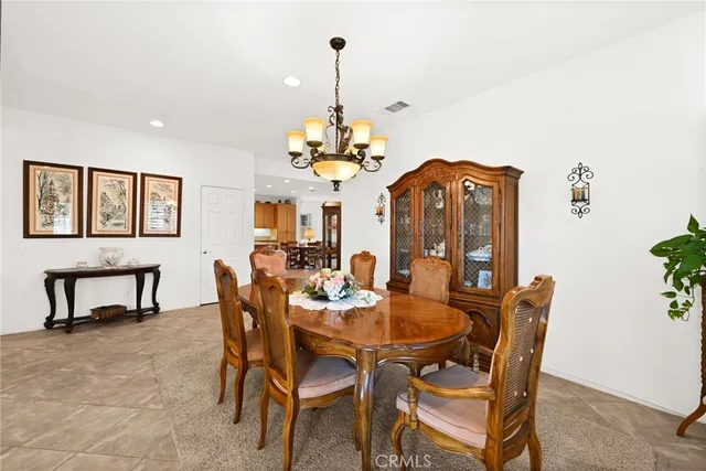 a dining room with furniture a chandelier and window