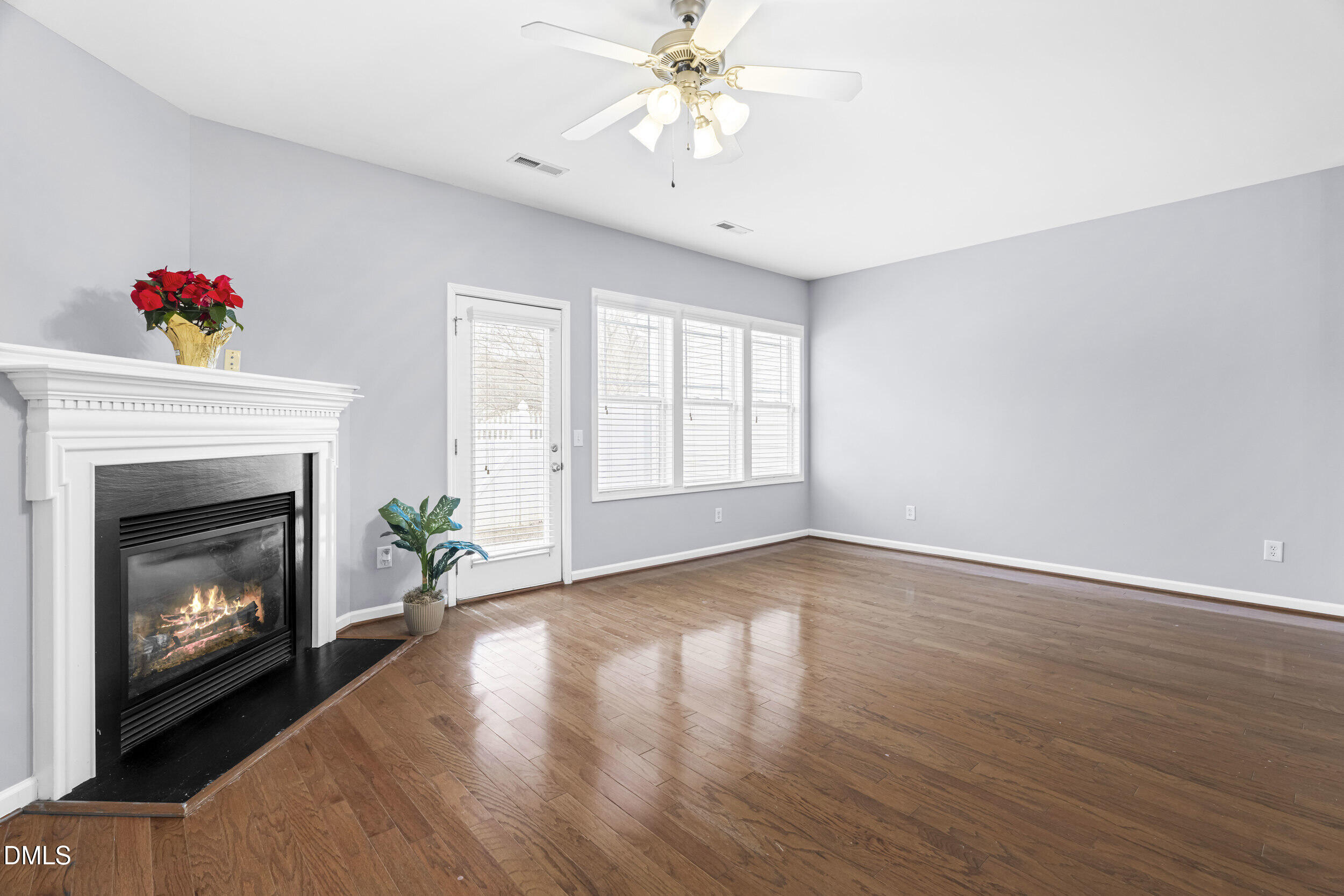 2636 Asher View Court Raleigh, NC 27606 - Photo 11 of 35 a living room with wooden floor and a fireplace