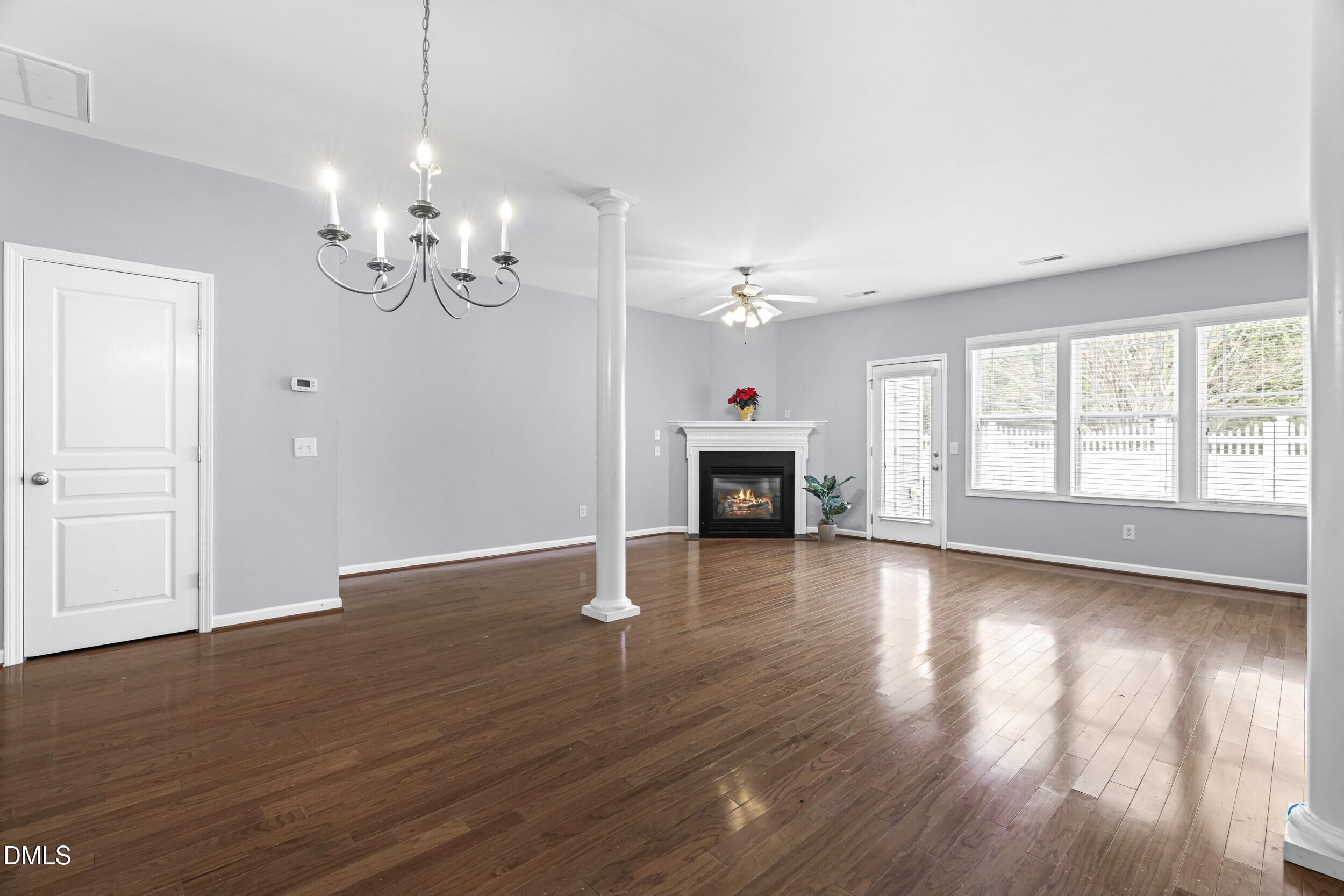 2636 Asher View Court Raleigh, NC 27606 - Photo 4 of 35 a view of empty room with wooden floor and fireplace