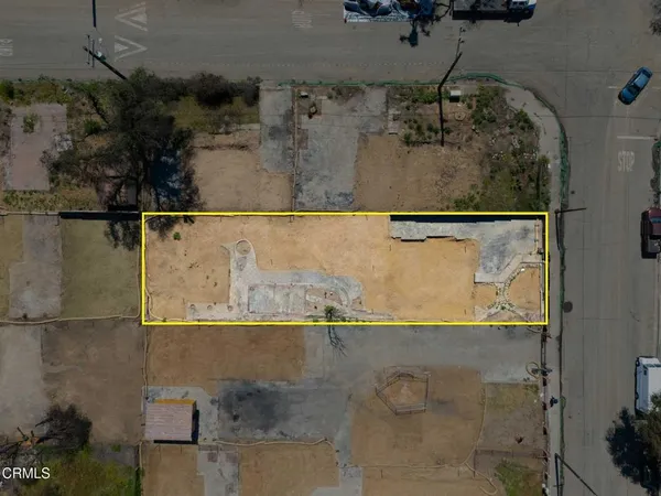 an aerial view of a house with a yard