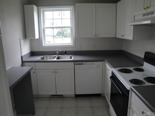 4913 Windsprint Way Raleigh, NC 27616 - Photo 3 of 5 a kitchen with a sink stove and cabinets