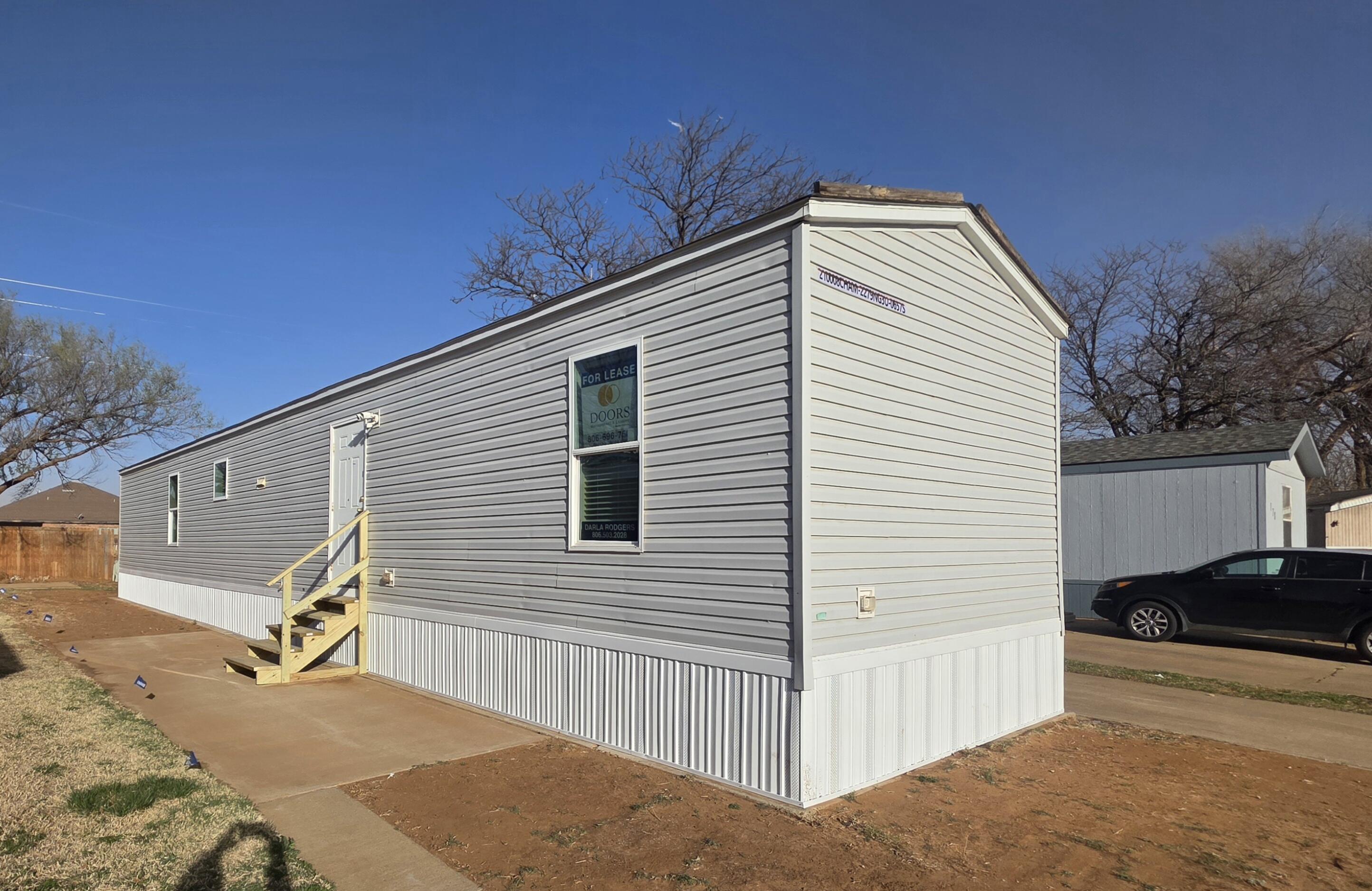 6801 19th Street, Unit 179 Lubbock, TX 79407 - Photo 1 of 15 a view of a house with a backyard and couches