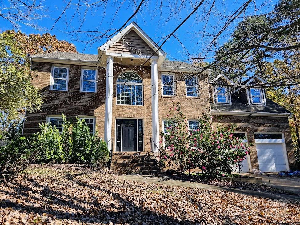 a view of a house with brick walls and potted plants
