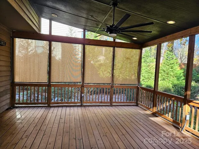 a balcony with wooden floor and outdoor seating