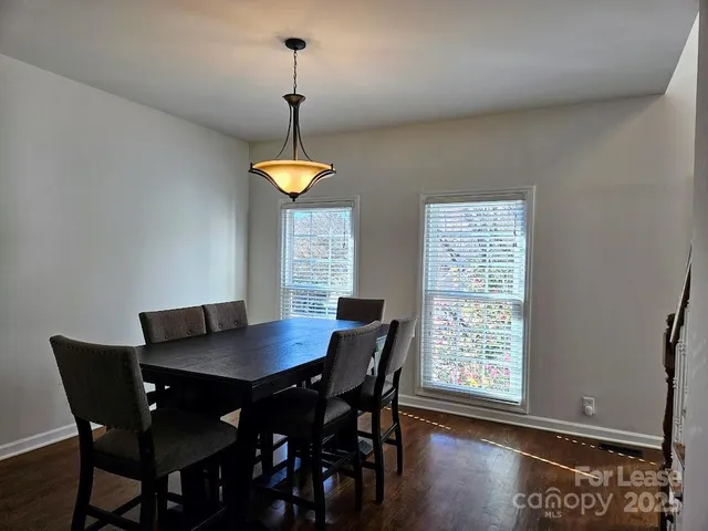 a view of a dining room with a table and chairs