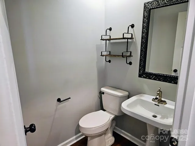 a bathroom with a sink mirror and toilet