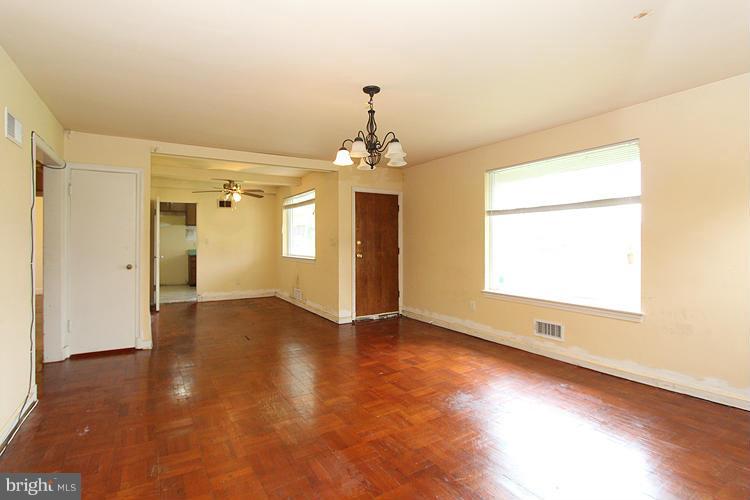 10510 Rodney Road Silver Spring, MD 20903 - Photo 8 of 30 an empty room with wooden floor and windows