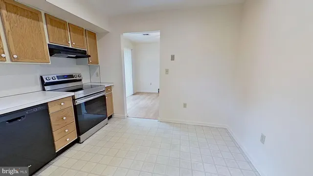 a kitchen with a stove top oven and cabinets