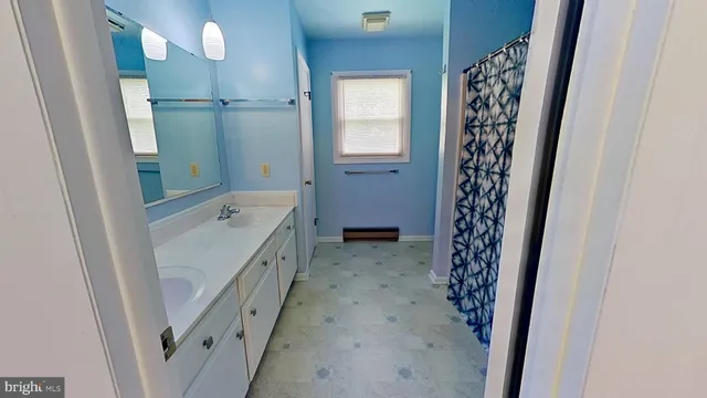 a bathroom with a bathtub and shower