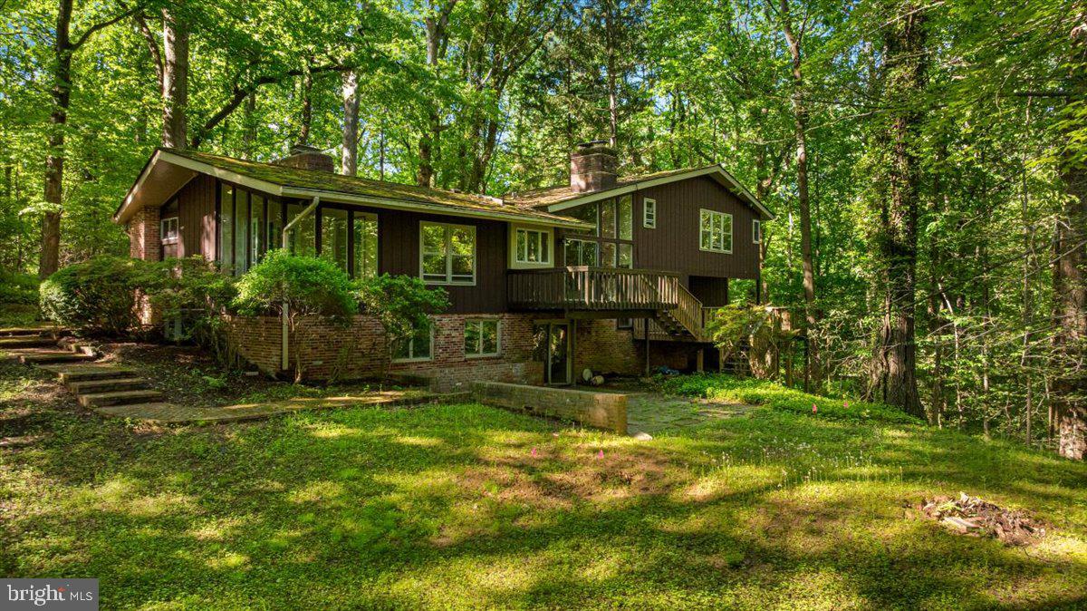 7818 Georgetown Pike McLean, VA 22102 - Photo 6 of 25 a view of a house with backyard and sitting area