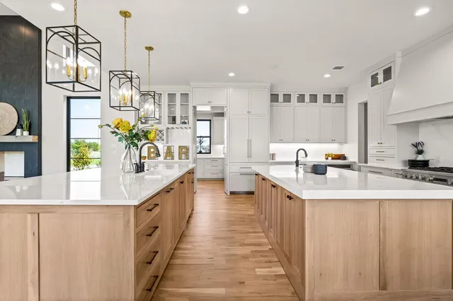 a kitchen with stainless steel appliances kitchen island granite countertop a sink and a refrigerator