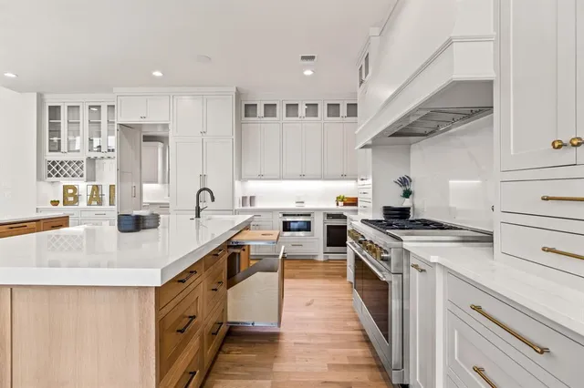 a kitchen with a sink a stove and cabinets