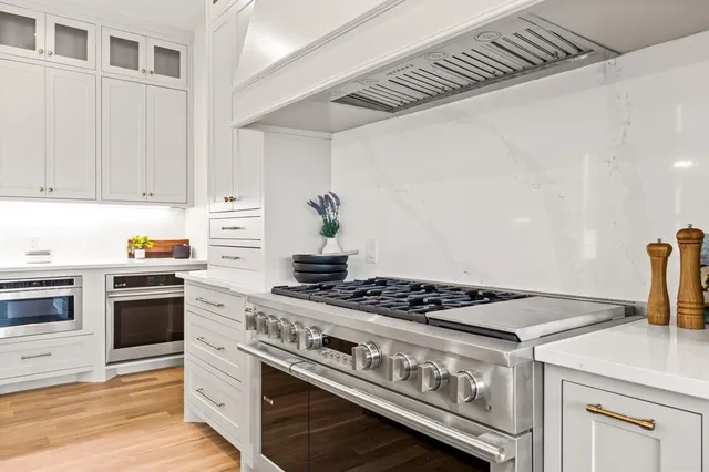 a white stove top oven sitting inside of a kitchen