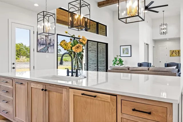 a kitchen with stainless steel appliances granite countertop a sink and window