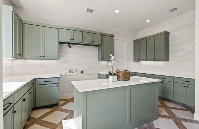 a kitchen with sink cabinets and microwave
