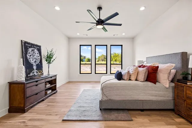 a bedroom with a large bed and a large window