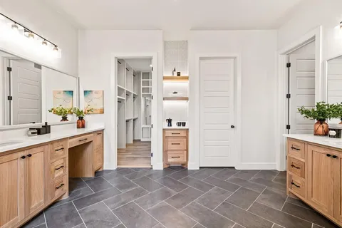 a large white kitchen with cabinets and stainless steel appliances
