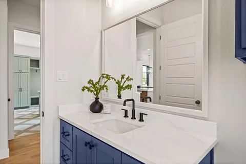 a bathroom with a sink a vanity and a mirror