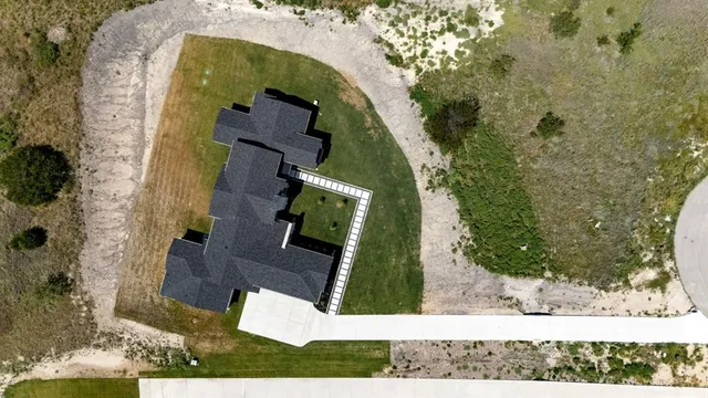 an aerial view of a house with a yard