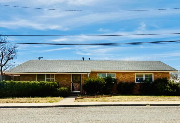 a view of house with swimming pool and yard