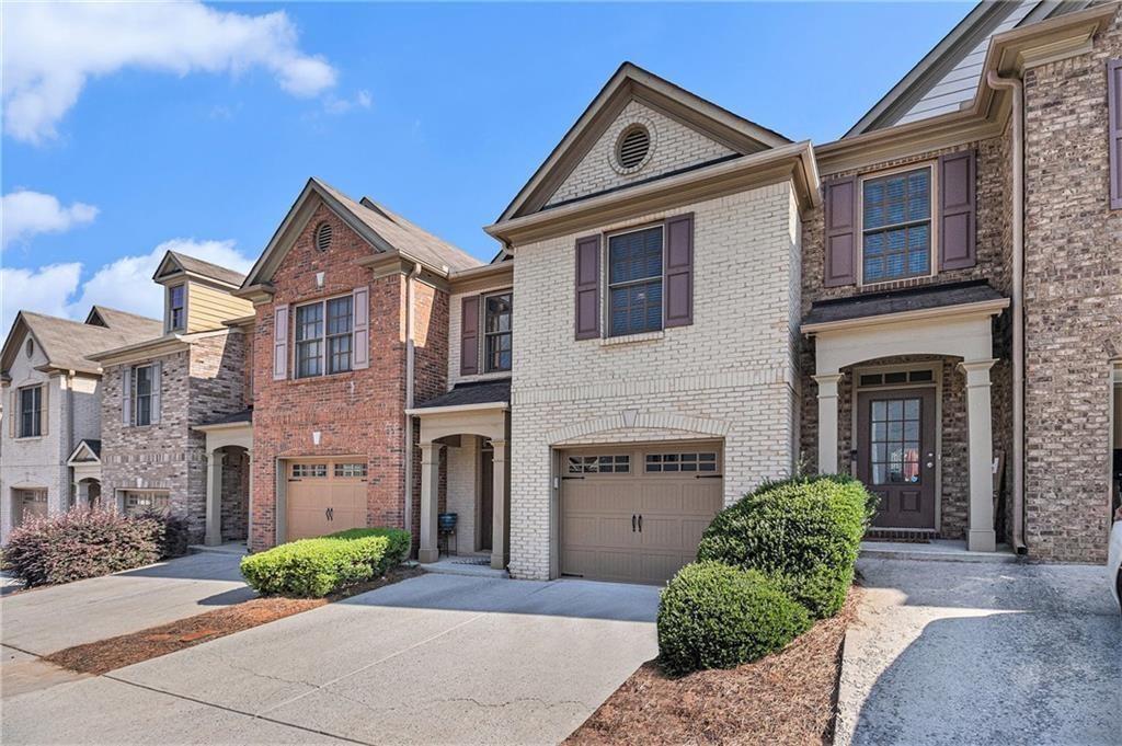 350 Beynon Terrace Suwanee, GA 30024 - Photo 2 of 7 a front view of a house with a yard and garage