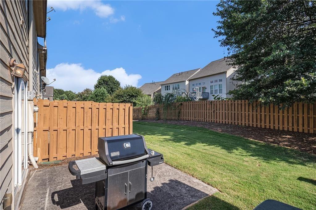 350 Beynon Terrace Suwanee, GA 30024 - Photo 5 of 7 a view of a yard with a wooden fence