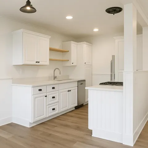 a kitchen with cabinets appliances and a wooden floor