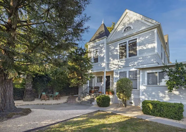 a view of a house with backyard porch and sitting area