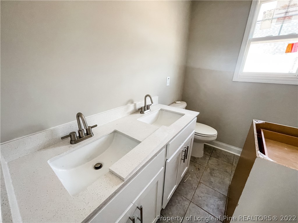 185 Winnsboro (lt113) Road Raeford, NC 28376 - Photo 16 of 19 a bathroom with a sink and a toilet