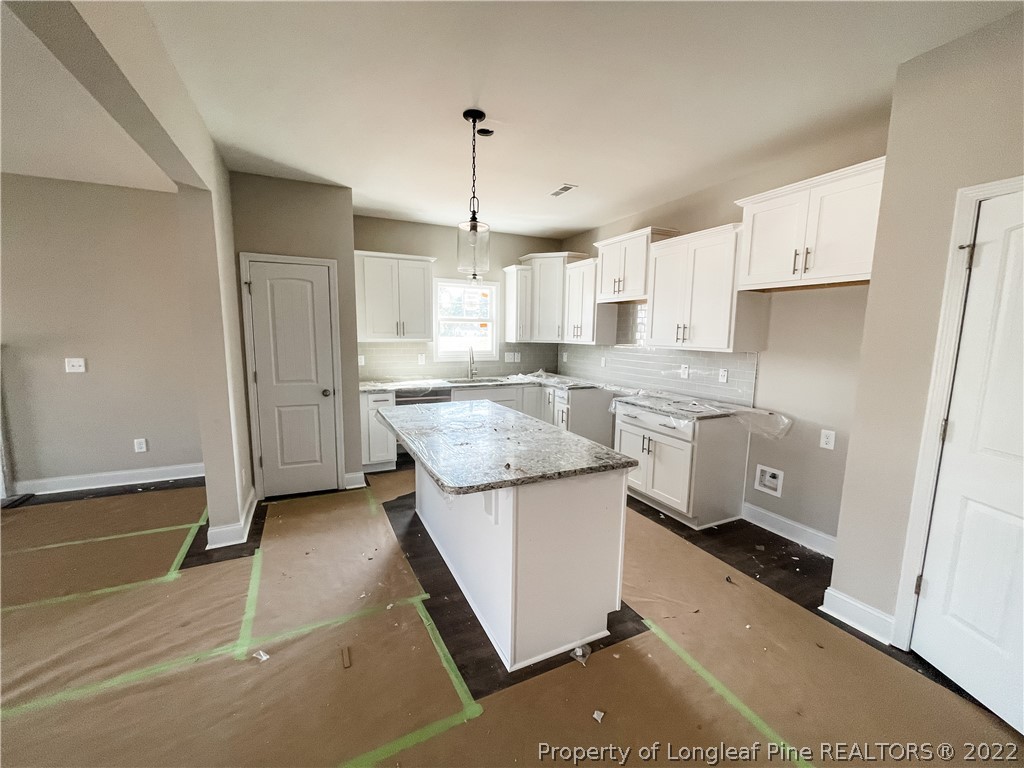 185 Winnsboro (lt113) Road Raeford, NC 28376 - Photo 4 of 19 a kitchen with a sink a stove a refrigerator and white cabinets