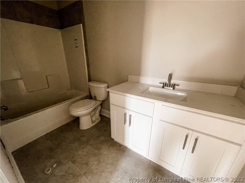 185 Winnsboro (lt113) Road Raeford, NC 28376 - Photo 8 of 19 a bathroom with a granite countertop sink toilet and shower