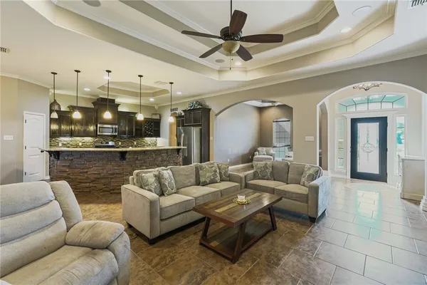 a living room with furniture and a chandelier