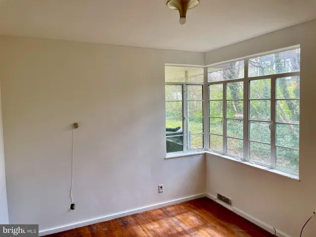 a view of room with window and hardwood floor