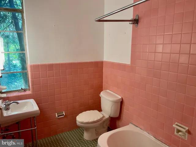 a bathroom with a toilet and a sink
