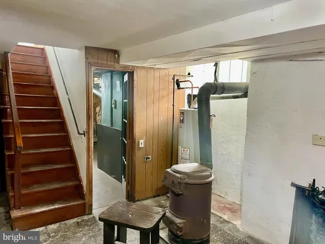 a view of hallway with stairs and wooden floor