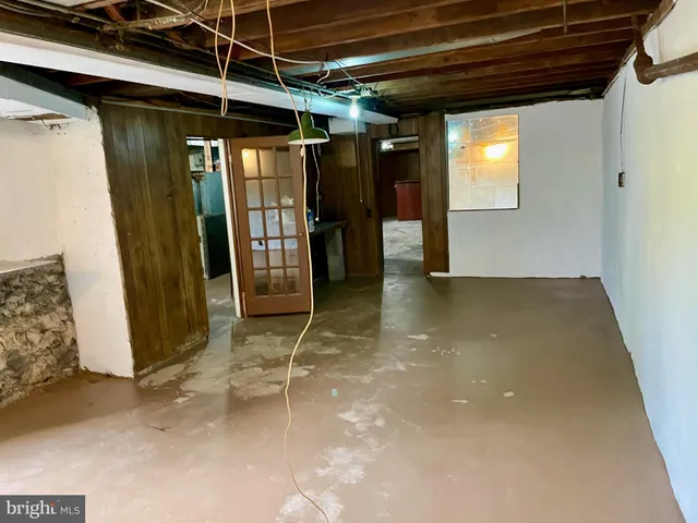 a view of a room with wooden floor and windows