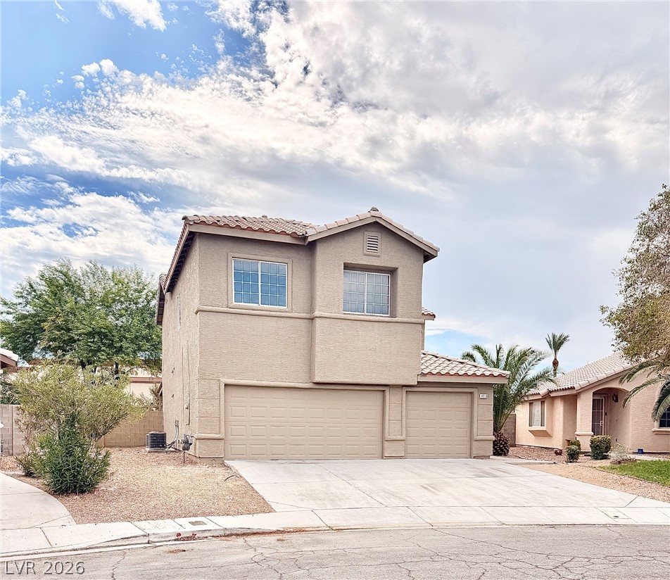 4313 Ranch Foreman Road North Las Vegas, NV 89032 - Photo 4 of 27 Stucco exterior siding and a Spanish tile roof define this two-story residential facade.