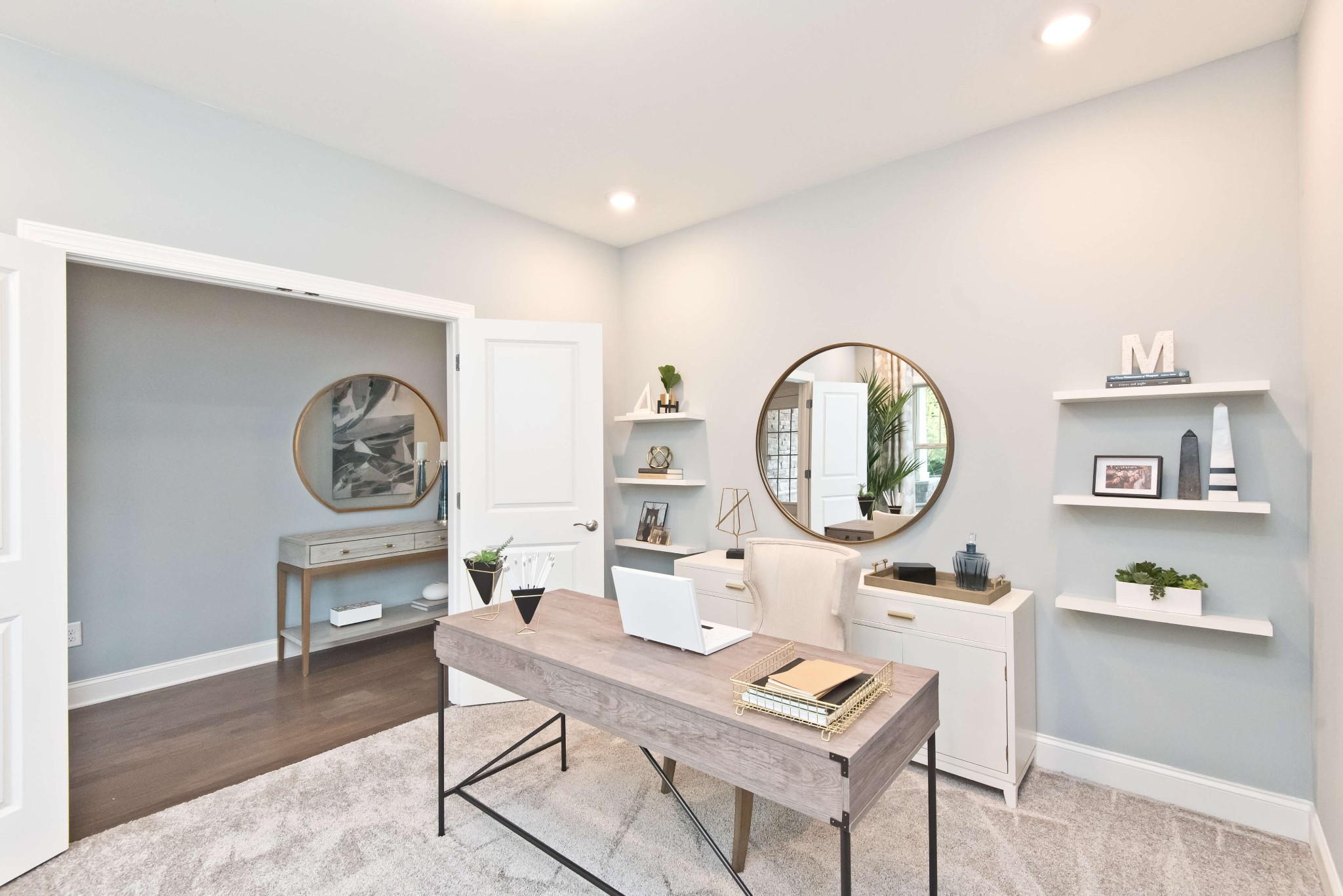 711 Castle Road Mount Juliet, TN 37122 - Photo 8 of 19 a living room with table and a clock on wall with wooden floor