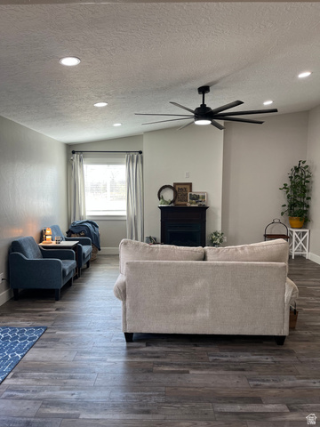 558 North N Cres Road Roosevelt, UT 84066 - Photo 7 of 31 Spacious room featuring wood-finish flooring, a contemporary ceiling fan, recessed lighting, and a prominent fireplace with a dark mantel