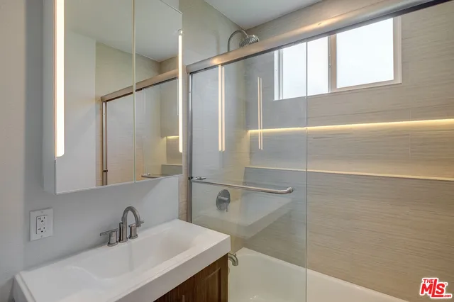 a bathroom with a sink and a mirror