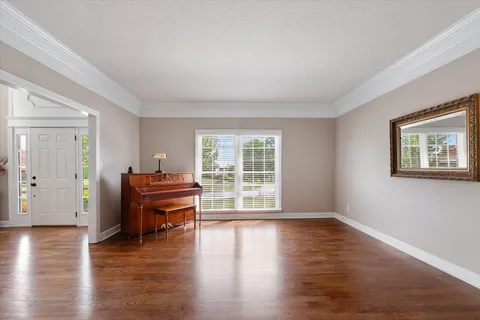 a kitchen with stainless steel appliances granite countertop a refrigerator a sink dishwasher a stove and a refrigerator with wooden cabinets