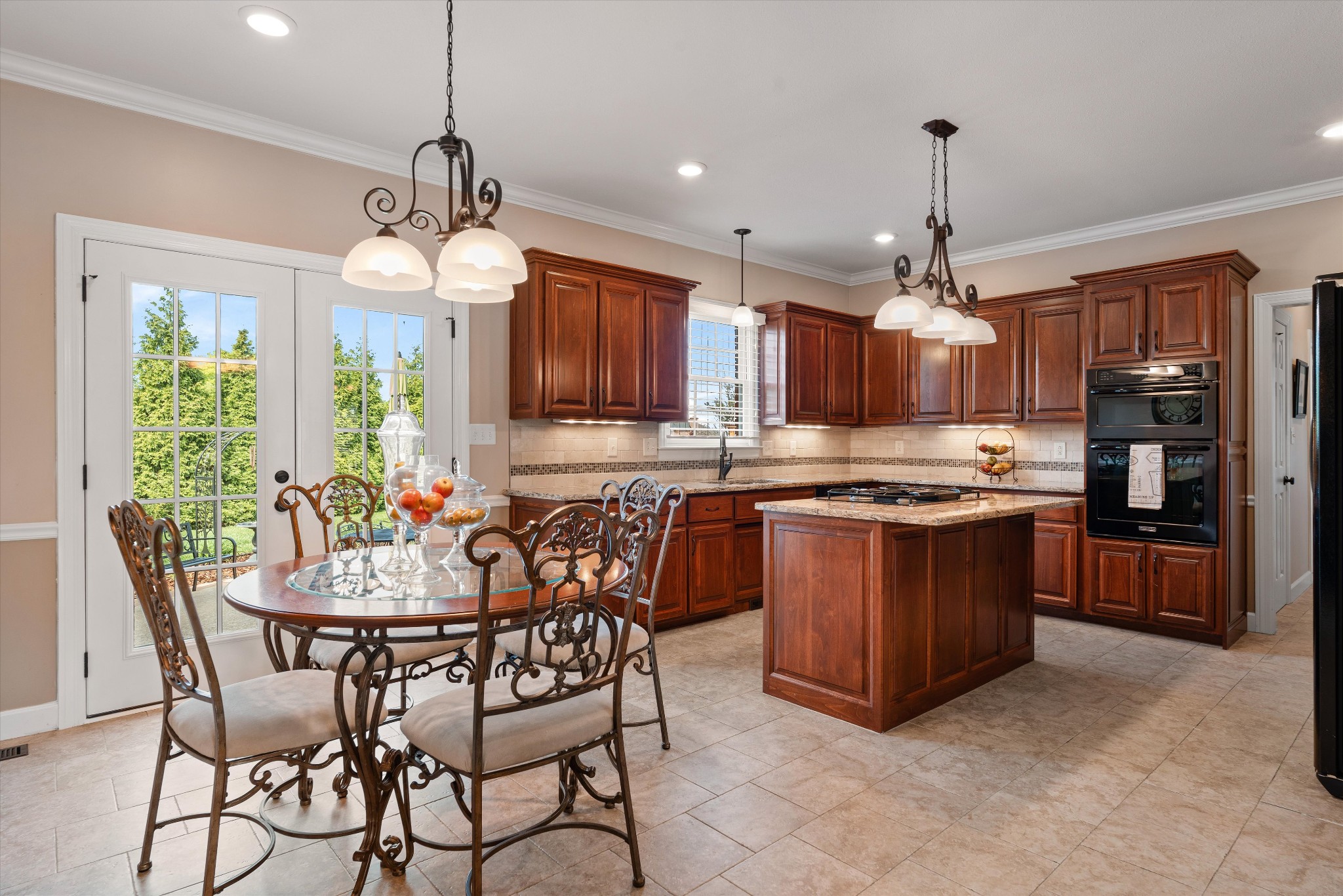 506 Pond Apple Road Clarksville, TN 37043 - Photo 15 of 73 a open kitchen with stainless steel appliances granite countertop a stove top oven a refrigerator a kitchen island a dining table and chairs