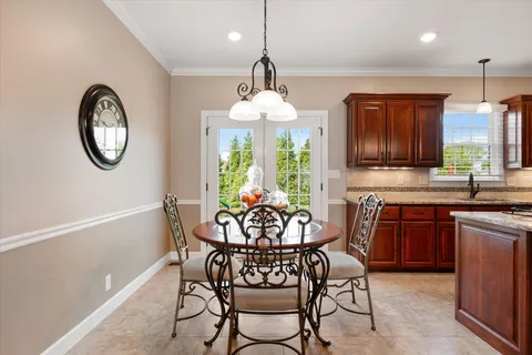 a living room with furniture a clock and a fireplace