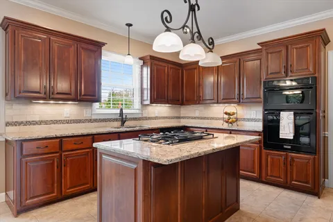 a living room with furniture a fireplace a clock and a window