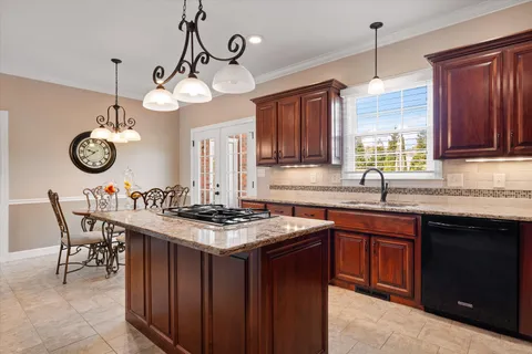 a bedroom with a bed and a couch next to a window