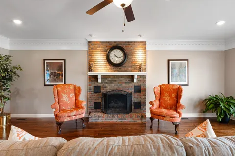 an empty room with windows and chandelier fan