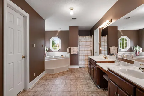 a view of a patio with a table chairs and a floor to ceiling window